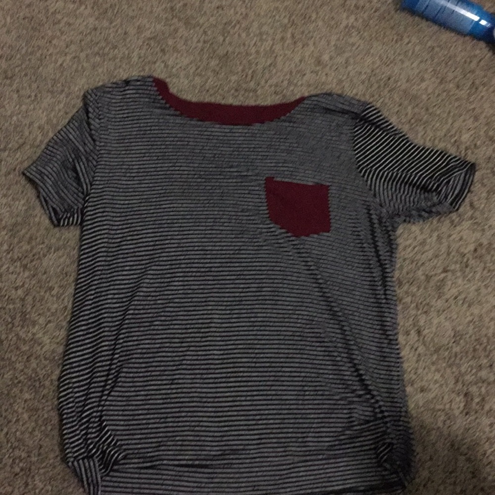 Black and white striped t shirt with a red pocket